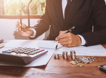businessman Writing paper and using calculator Calculating bonus